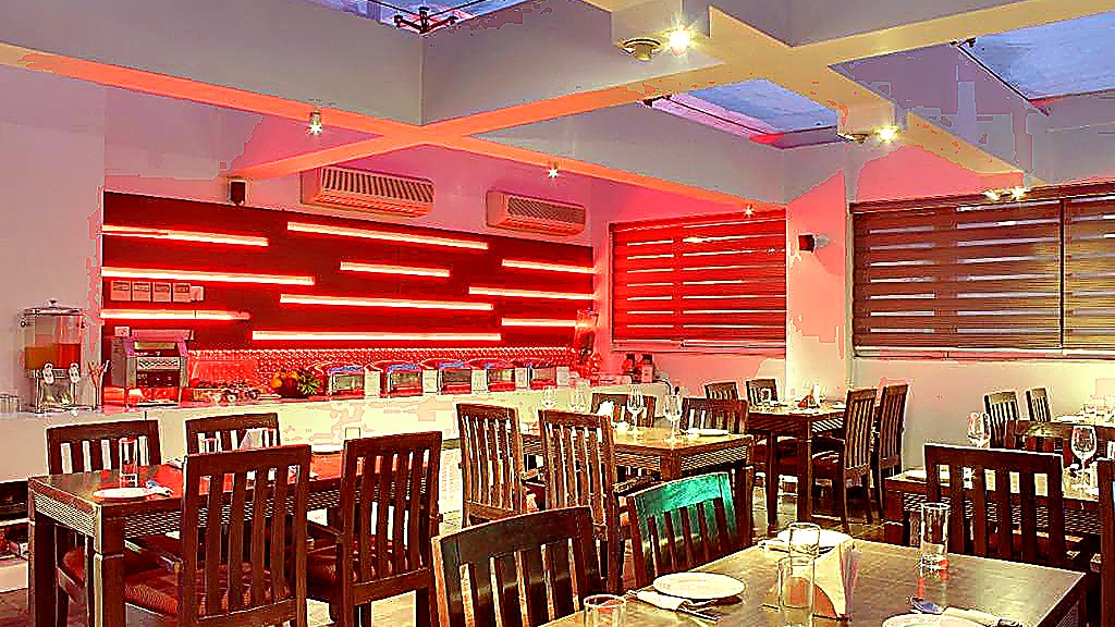 Grand Godwin Rooftop Lounge & Buffet Dining — indoor glass-ceiling buffet breakfast hall with warm ambient lighting at Hotel Grand Godwin New Delhi