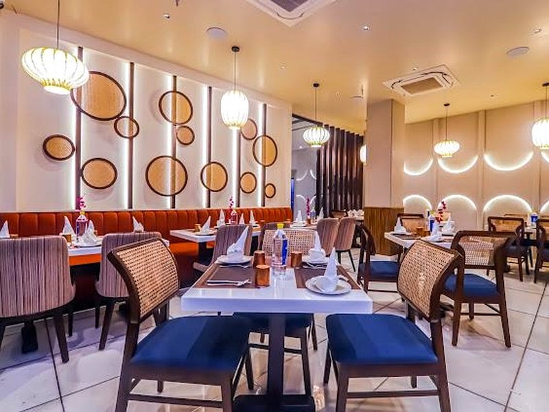 The Indian Grill restaurant interior at Hotel Godwin Deluxe — grand dining hall with ambient lighting